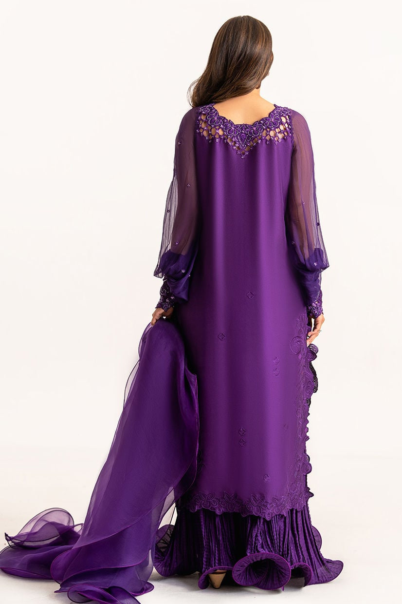 Purple evening gown with sheer sleeves on a white background