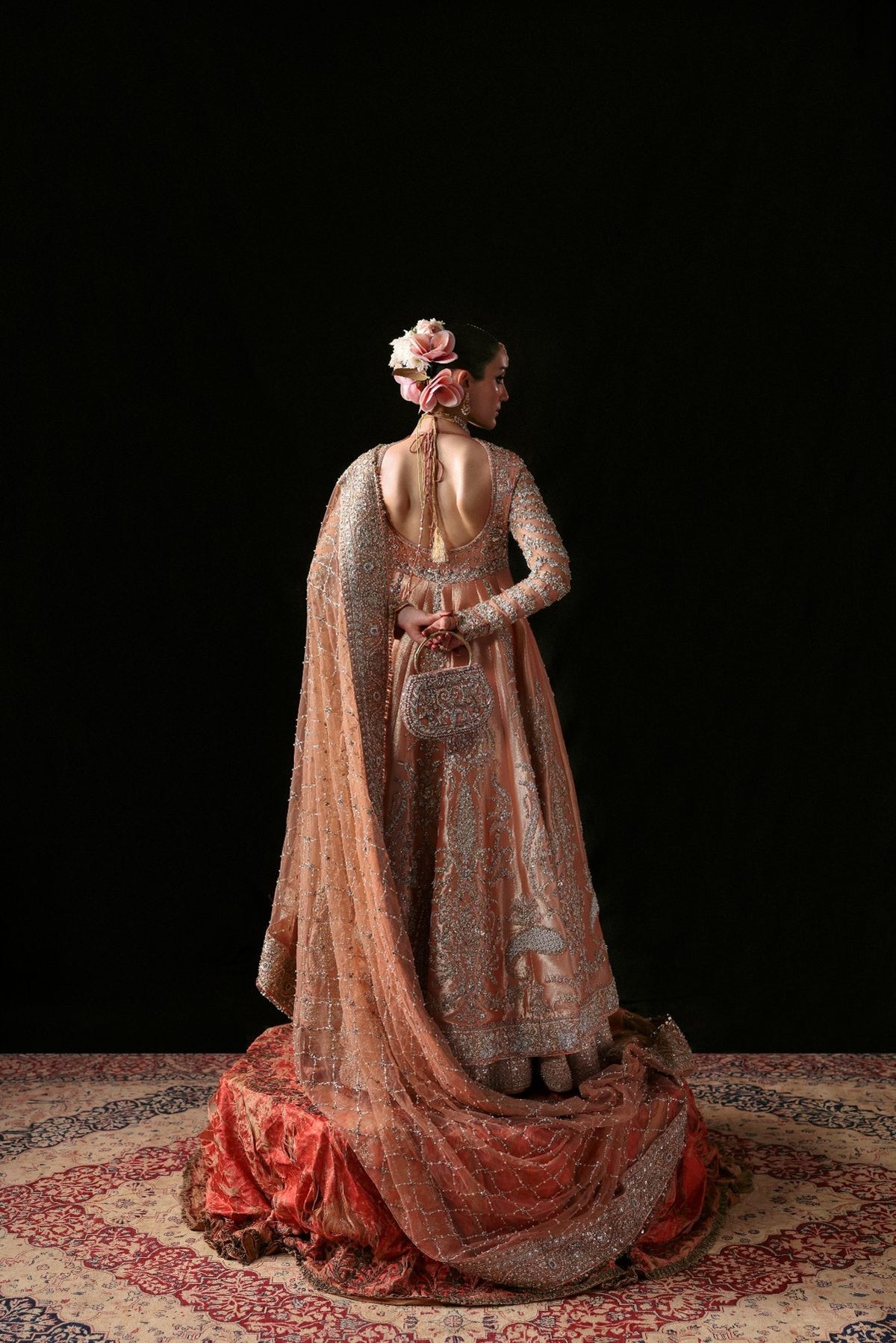 Woman in a traditional outfit with a dark background