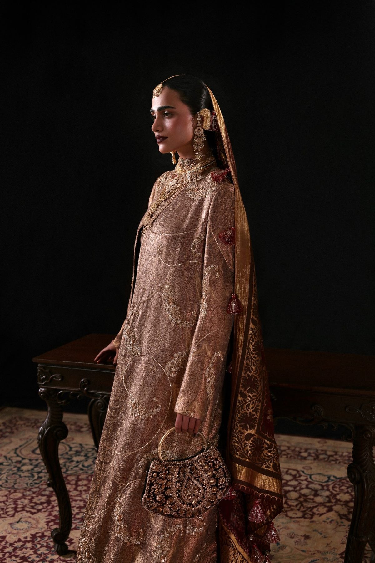 Woman in a traditional embroidered outfit with a dark background