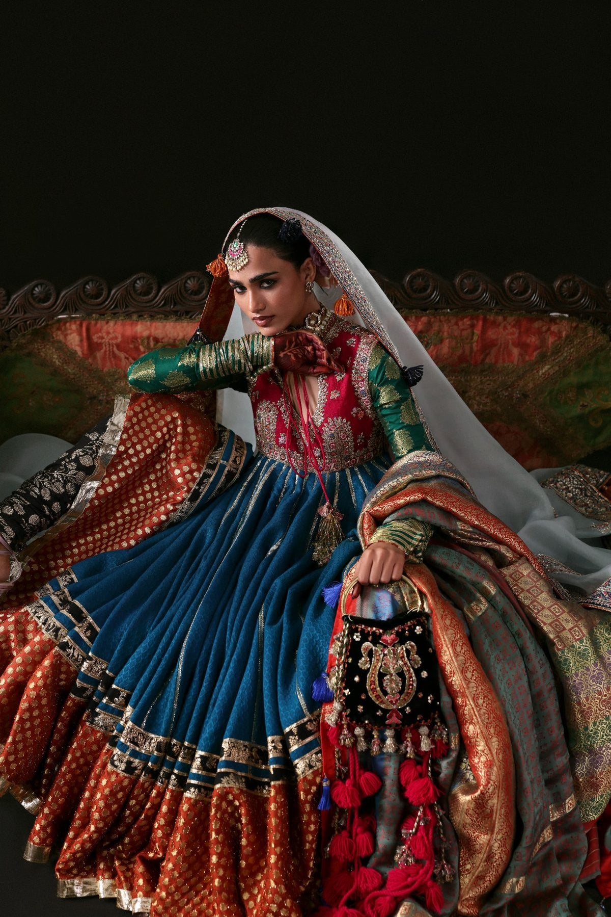 Woman in traditional embroidered outfit with a dark background