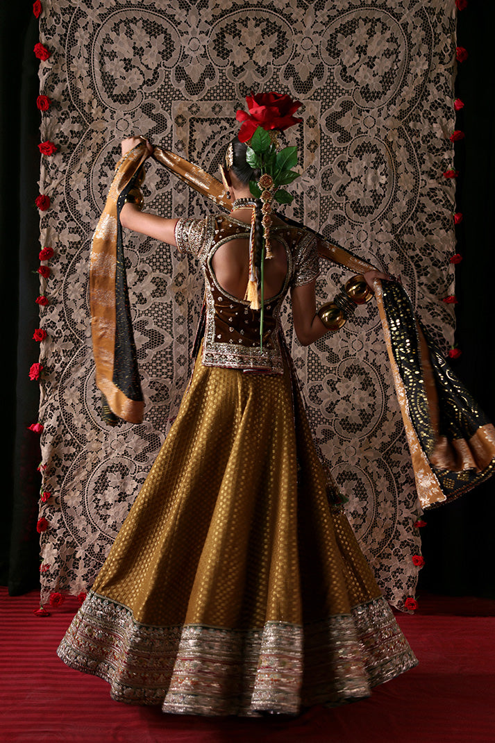 Dancer in traditional attire with a decorative backdrop