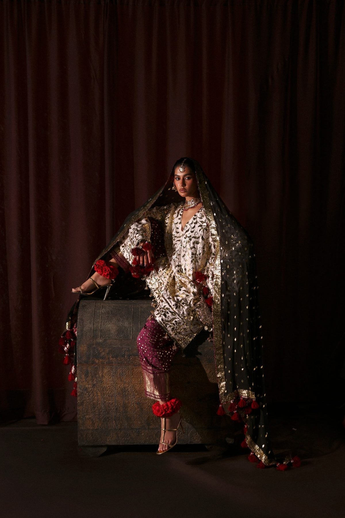 Woman in traditional attire with a dark background