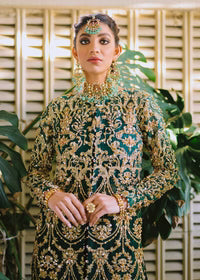 Elegant women’s traditional formal outfit in deep green with luxurious gold embroidery and a floor-length silhouette.