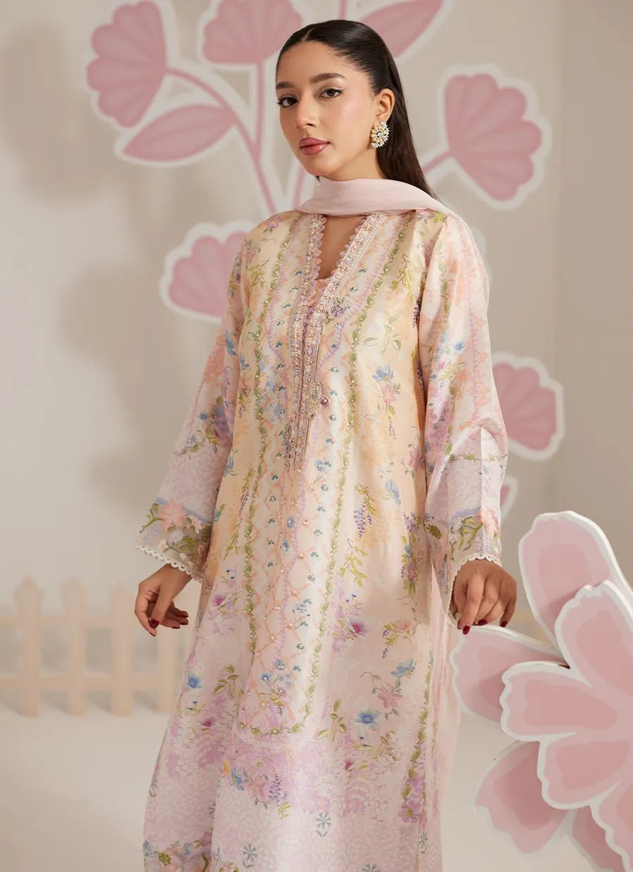 Woman wearing a floral dress with a soft pink background