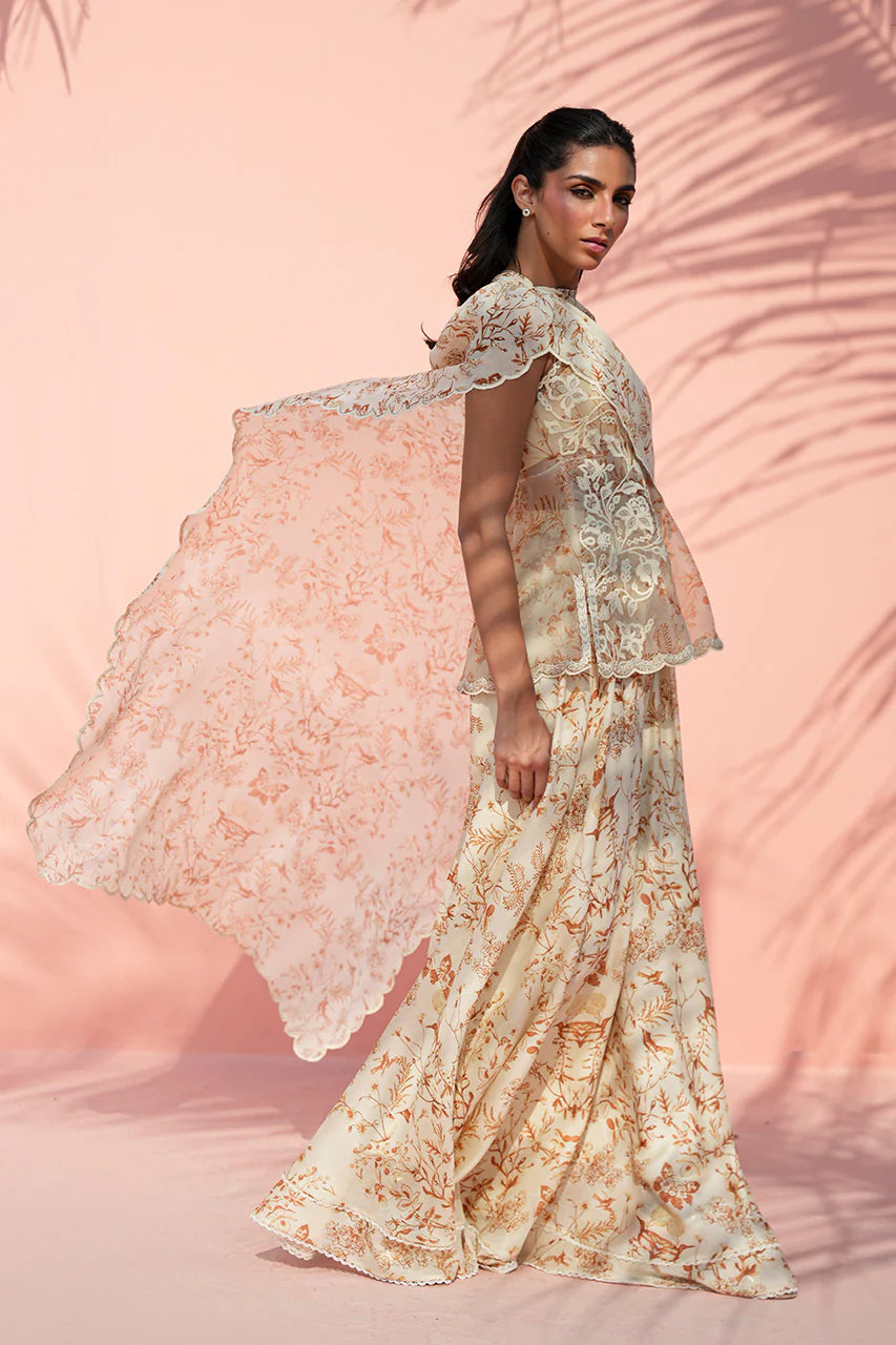 Woman wearing a floral outfit with a pink background
