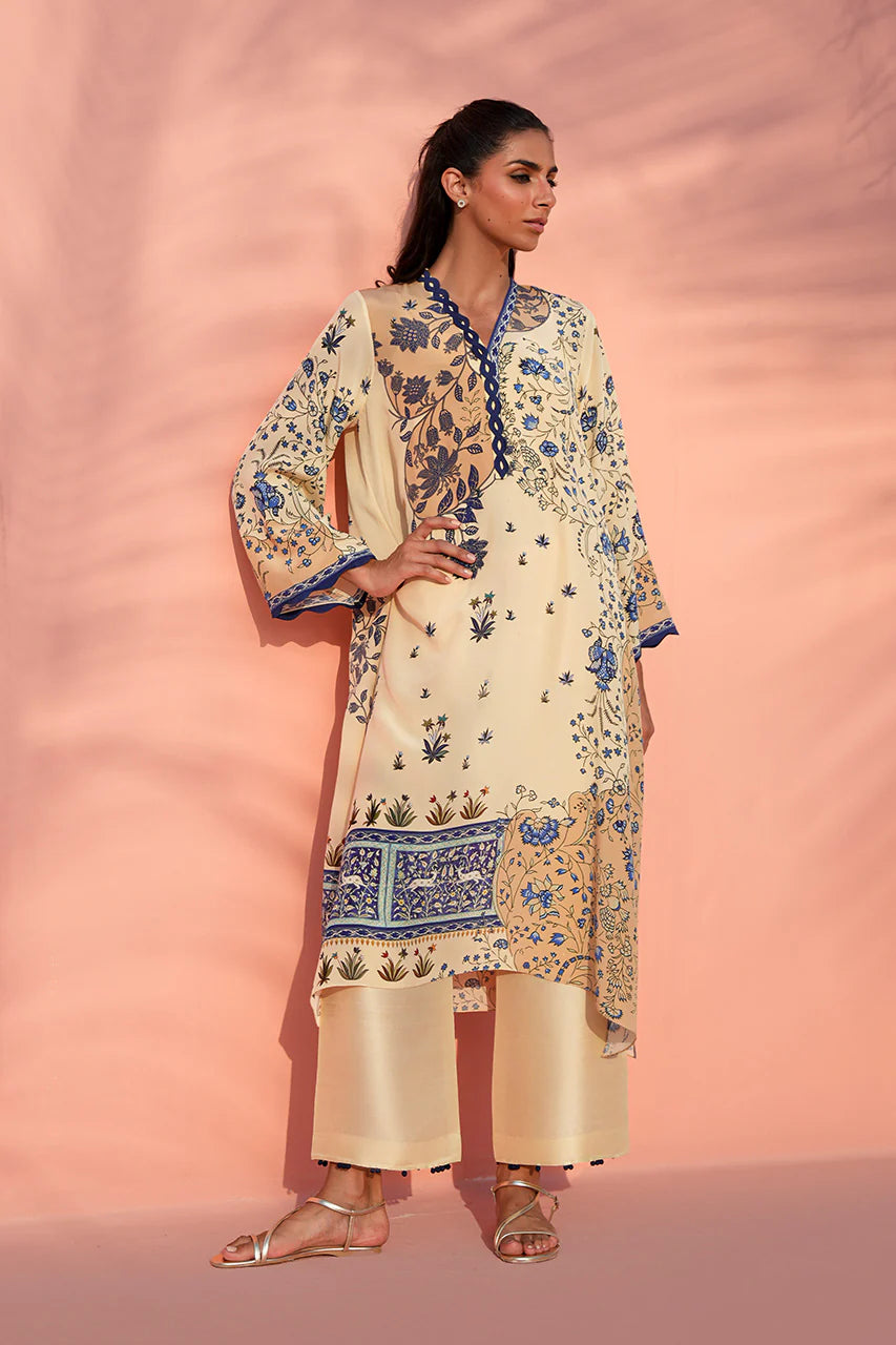 Woman wearing a floral embroidered outfit against a pink background