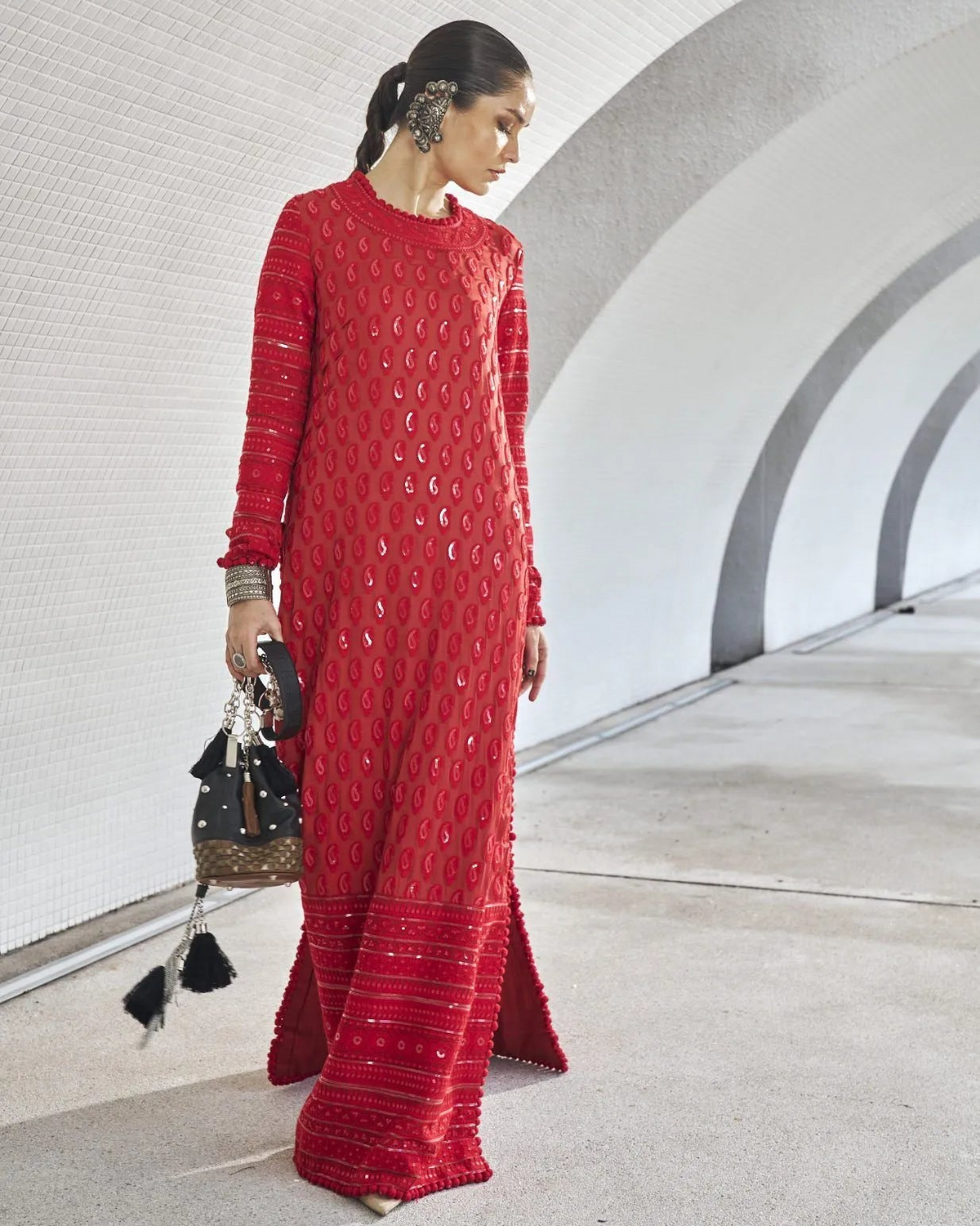 Woman in a red dress standing in a modern architectural setting