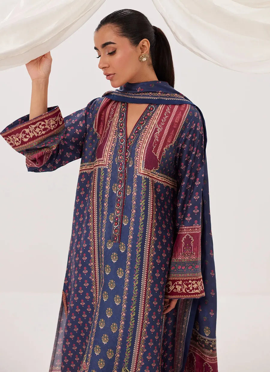 Woman wearing a blue and red patterned dress with a white background