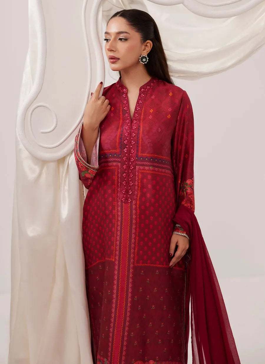 Woman wearing a red embroidered traditional outfit with a white background