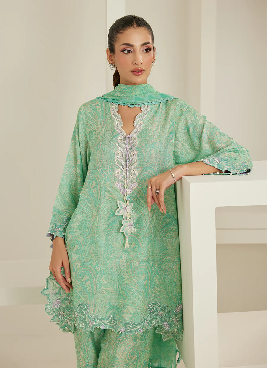 Woman wearing a green embroidered traditional outfit against a white background