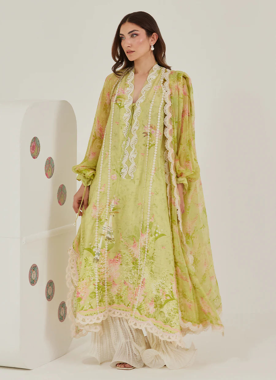 Woman wearing a light green floral dress with a white background