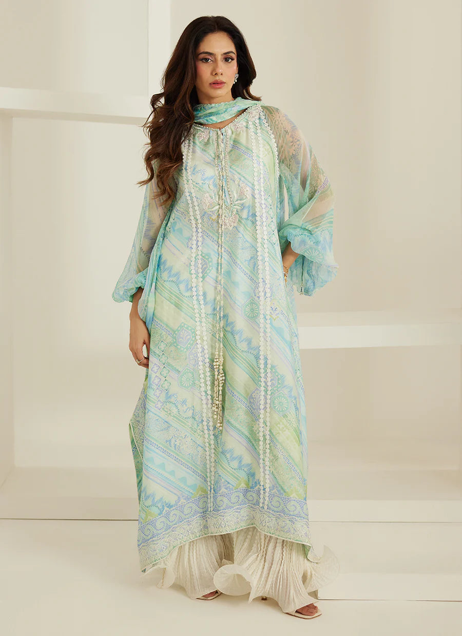 Woman wearing a light blue and green traditional outfit with a white background