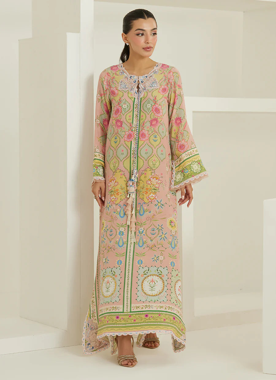 Woman wearing a long, floral embroidered dress against a white background