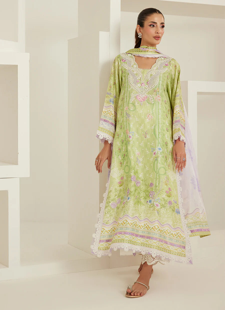 Woman wearing a light green embroidered dress with white lace in a minimalistic setting