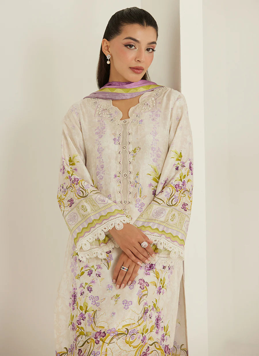 Woman wearing a floral embroidered outfit with a plain background