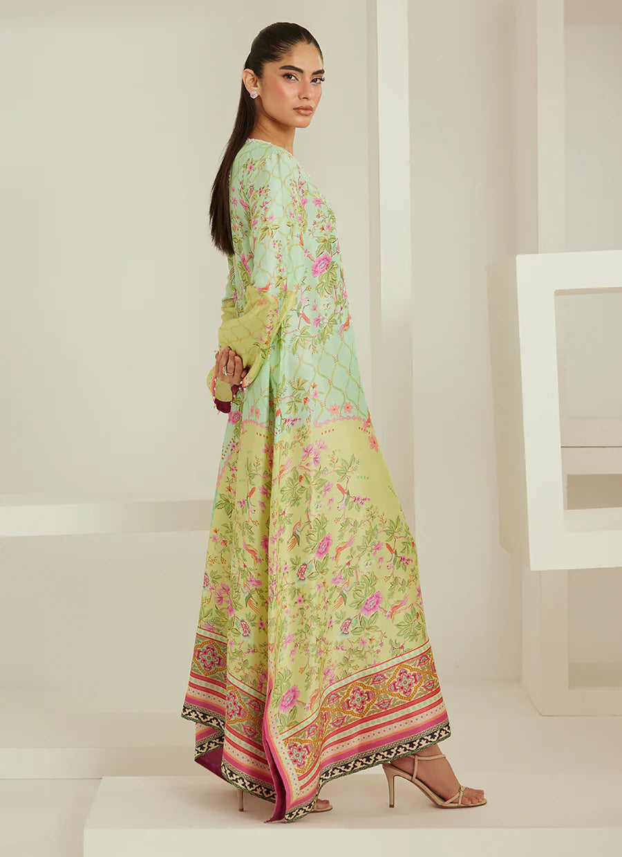 Woman wearing a light green floral dress with a white background