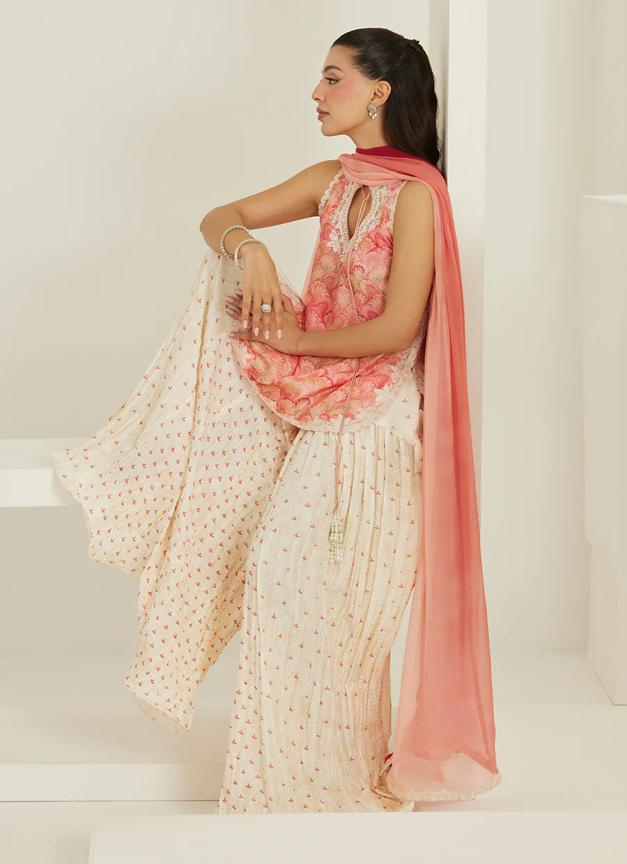 Woman wearing a pink and white saree with a white background
