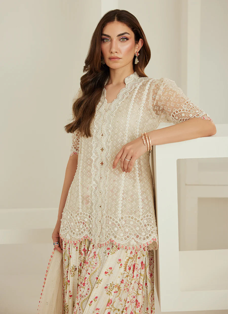 Woman wearing a floral dress with a neutral background
