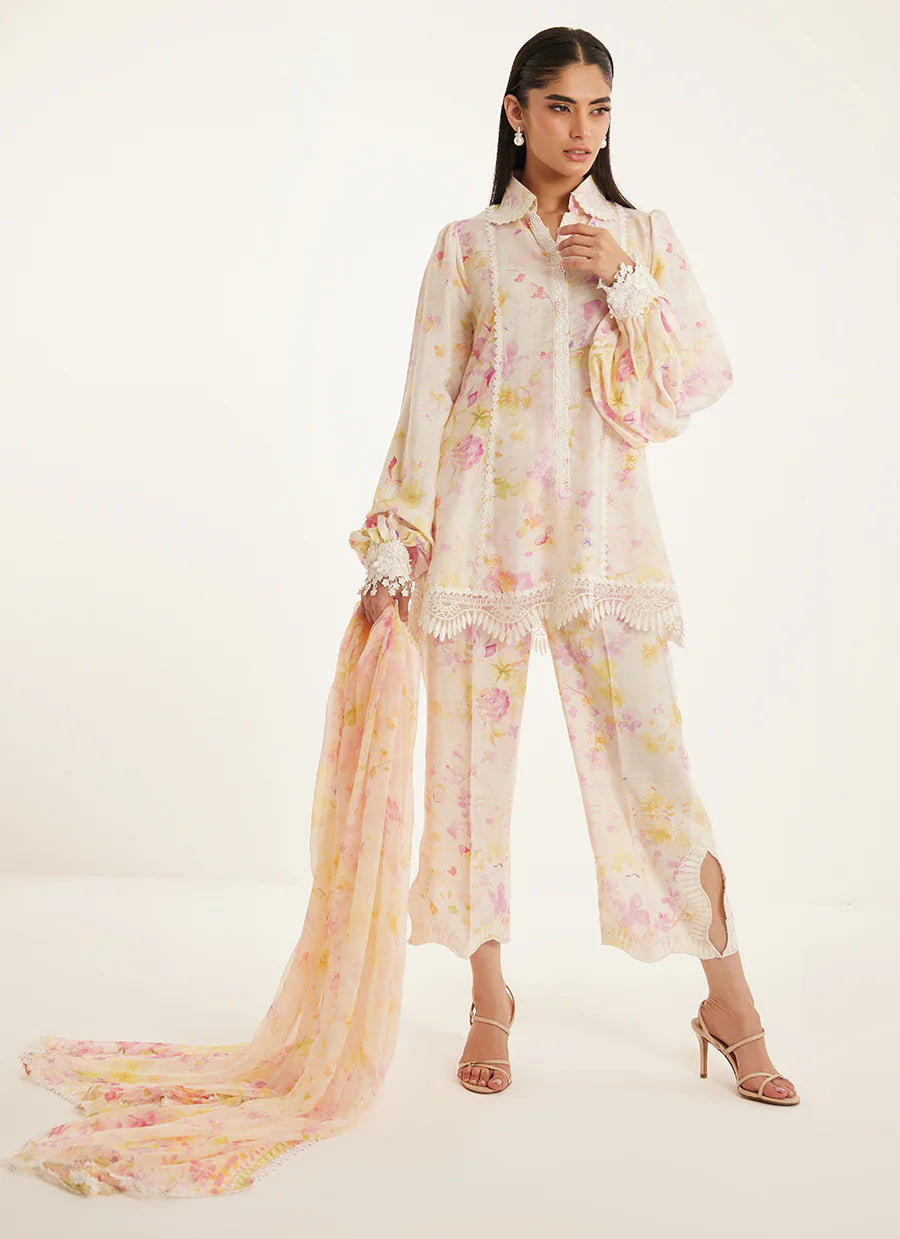 Woman wearing a floral outfit with a long scarf on a white background