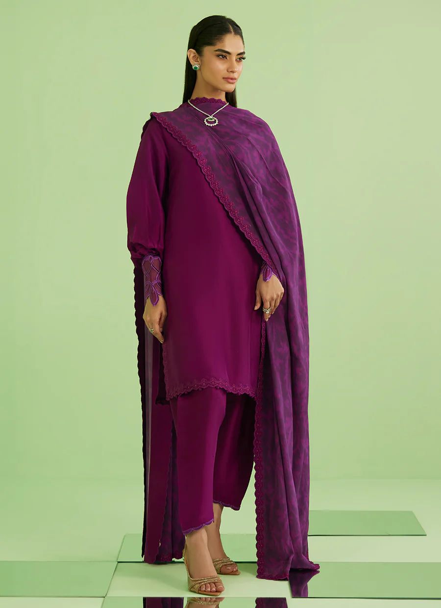 Woman wearing a purple outfit with a green background