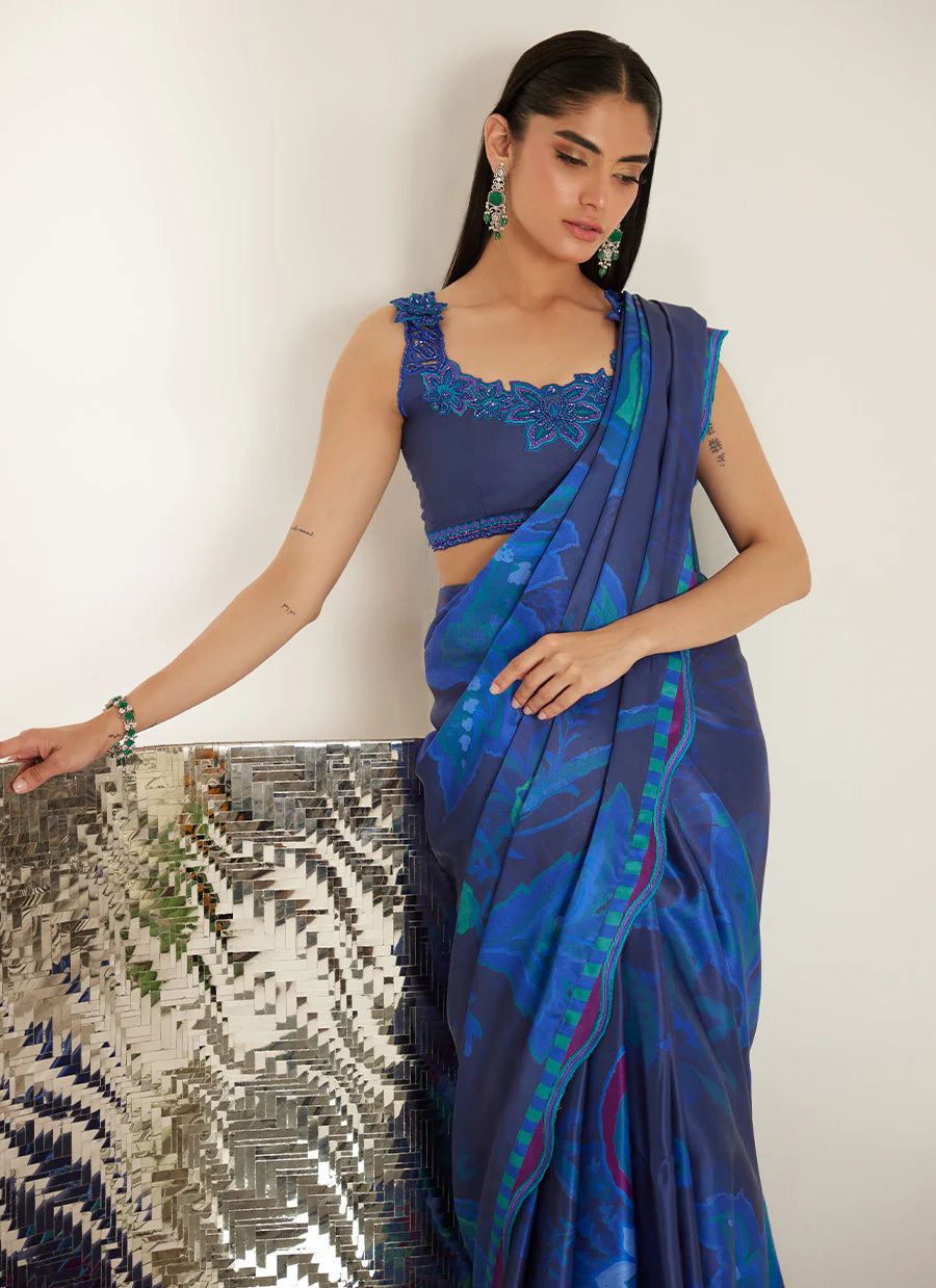 Woman wearing a blue saree with a white background