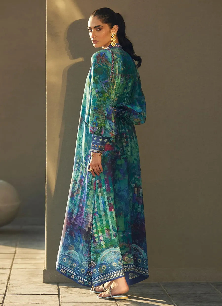 Woman wearing a colorful traditional outfit with a patterned design against a neutral background