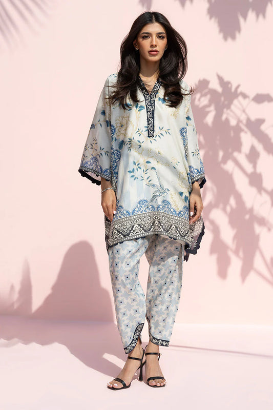 Woman wearing a floral outfit against a pink background