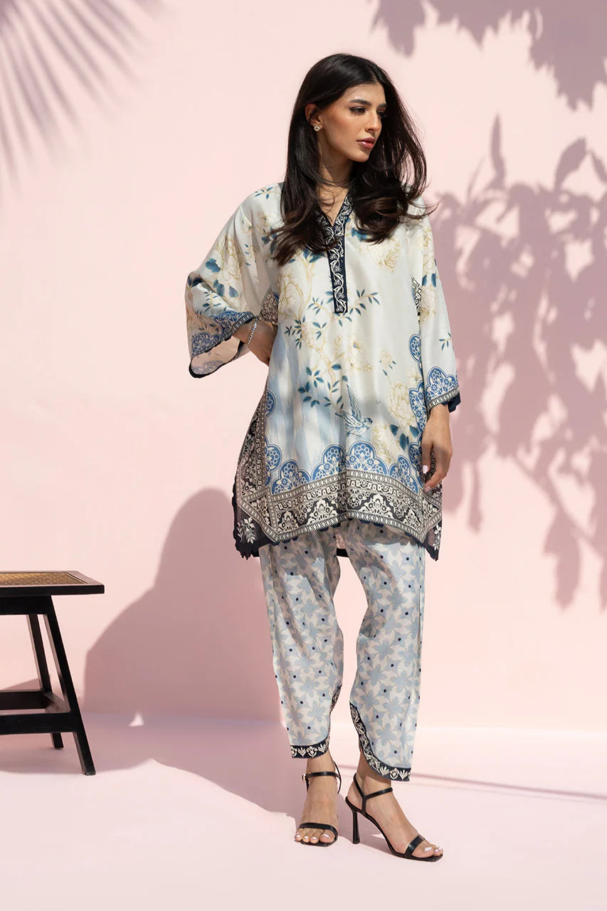 Woman wearing a floral outfit with a pink background