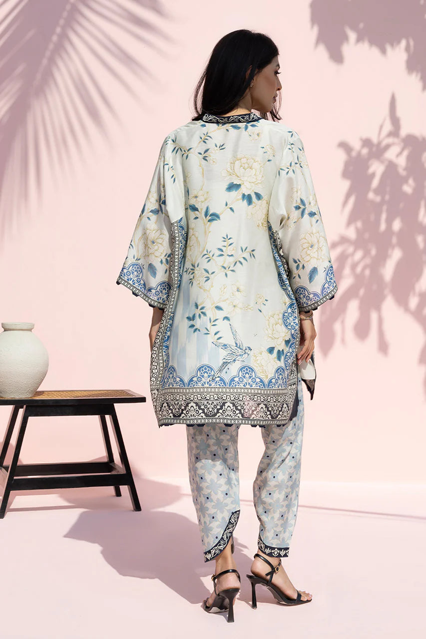 Woman wearing a floral outfit against a pink background