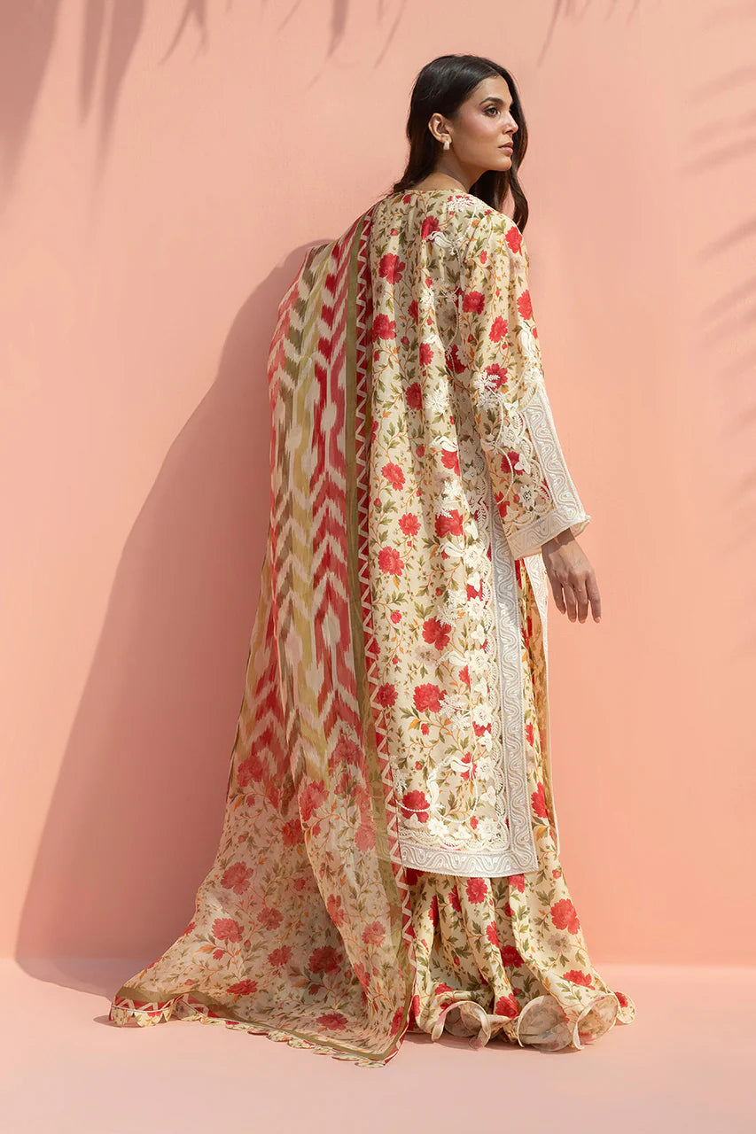 Woman wearing a floral outfit against a pink background