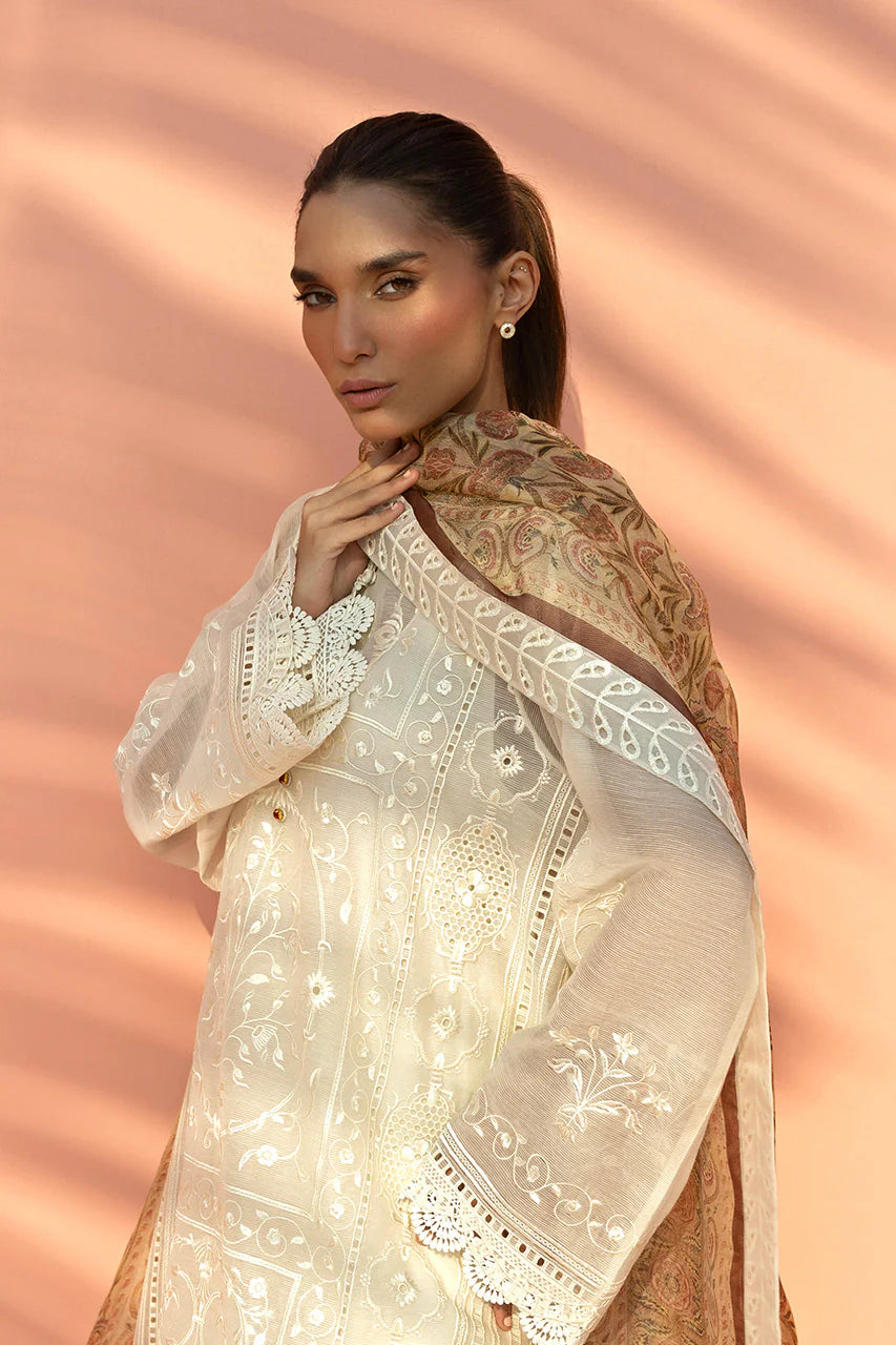 Woman wearing a cream-colored embroidered dupatta against a pink background