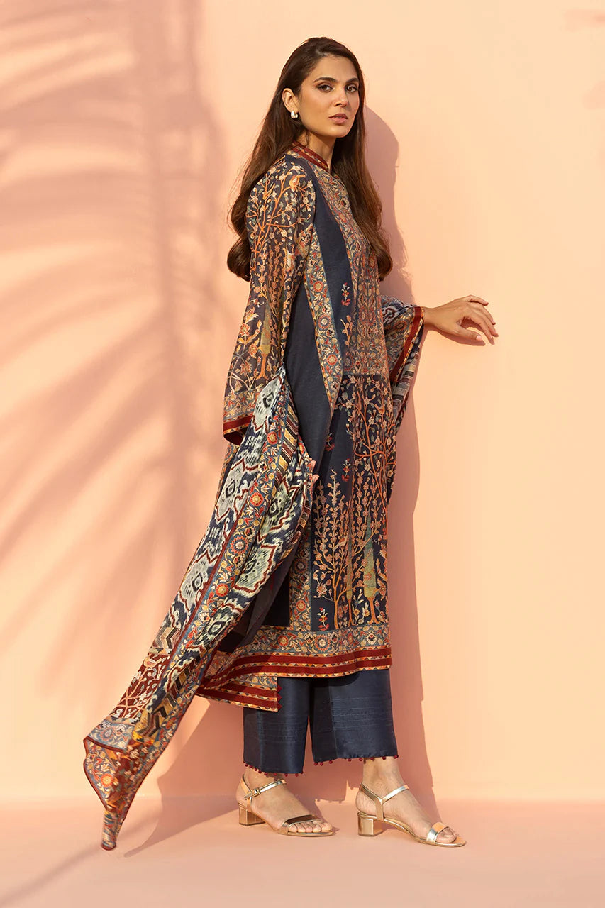 Woman wearing a patterned outfit against a pink background