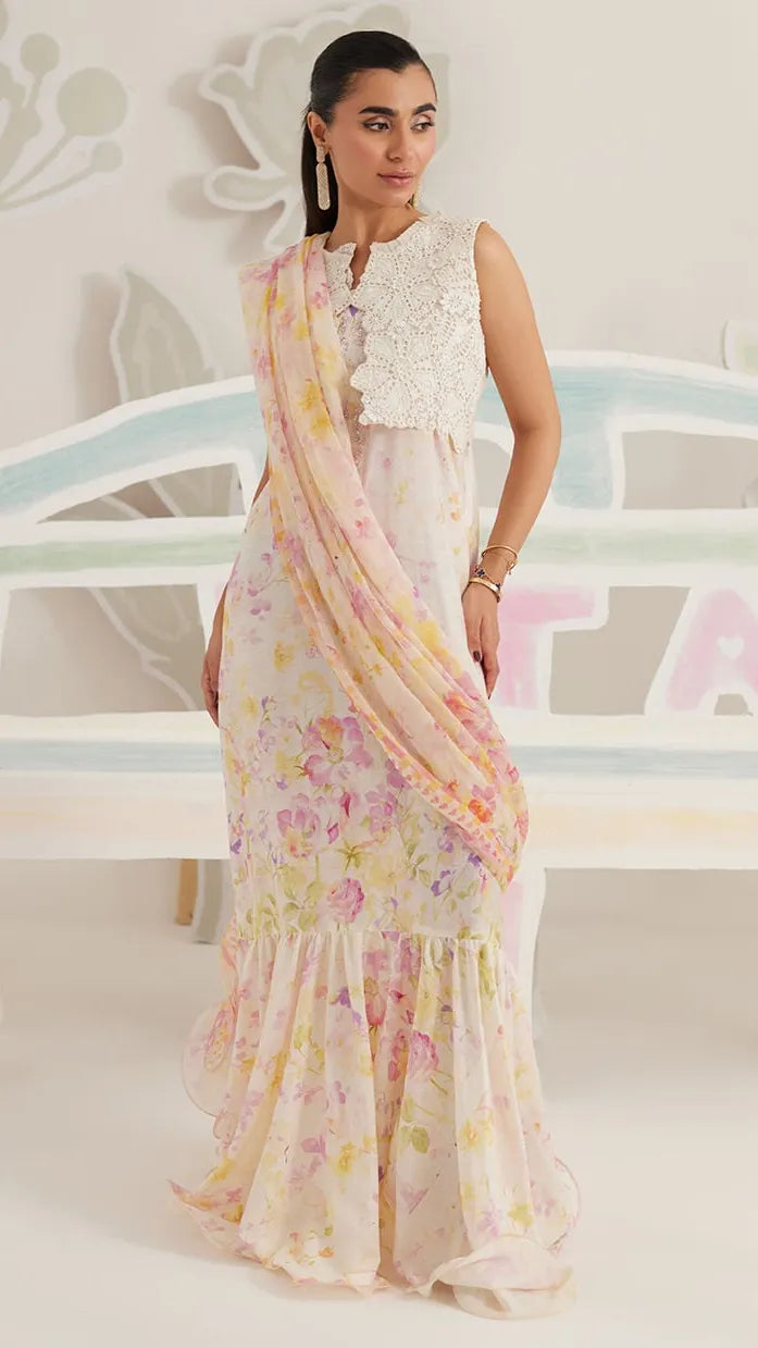 Woman wearing a floral dress with a white lace top in a decorative setting.