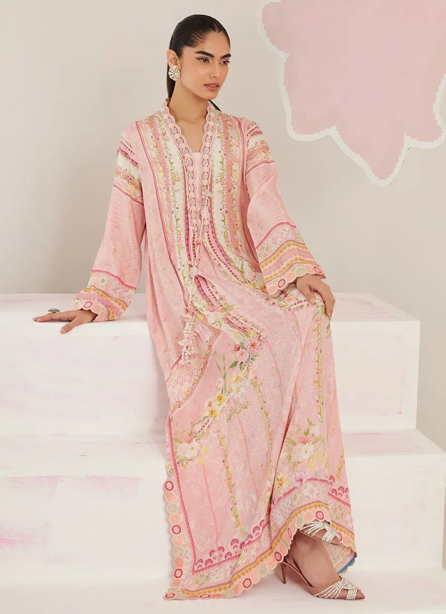 Woman wearing a pink embroidered traditional outfit on a white background