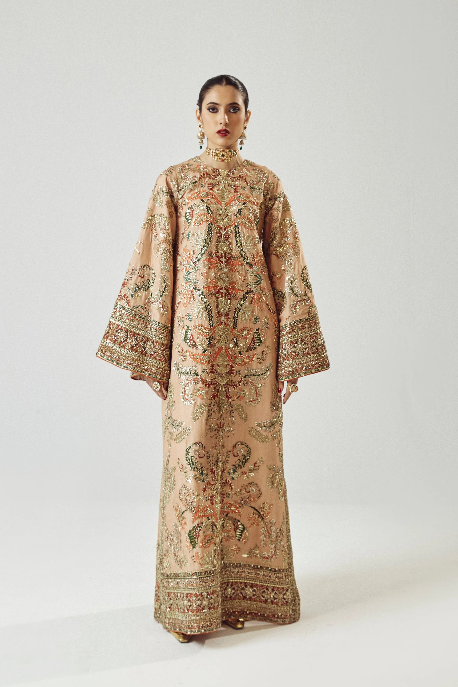 Woman wearing a patterned dress on a white background