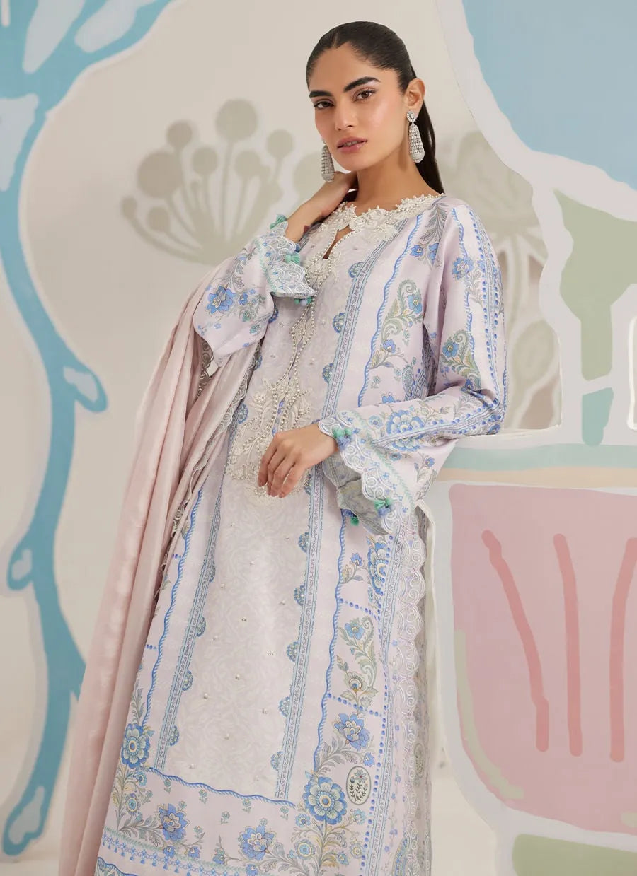 Woman wearing a floral dress with a pastel color scheme against an abstract background