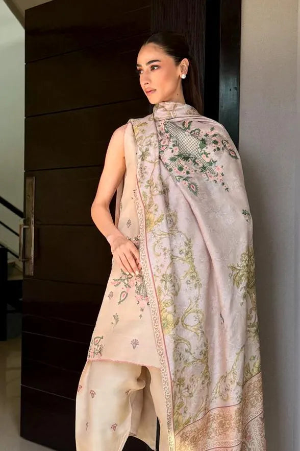 Woman wearing a floral dupatta draped over her shoulder indoors.
