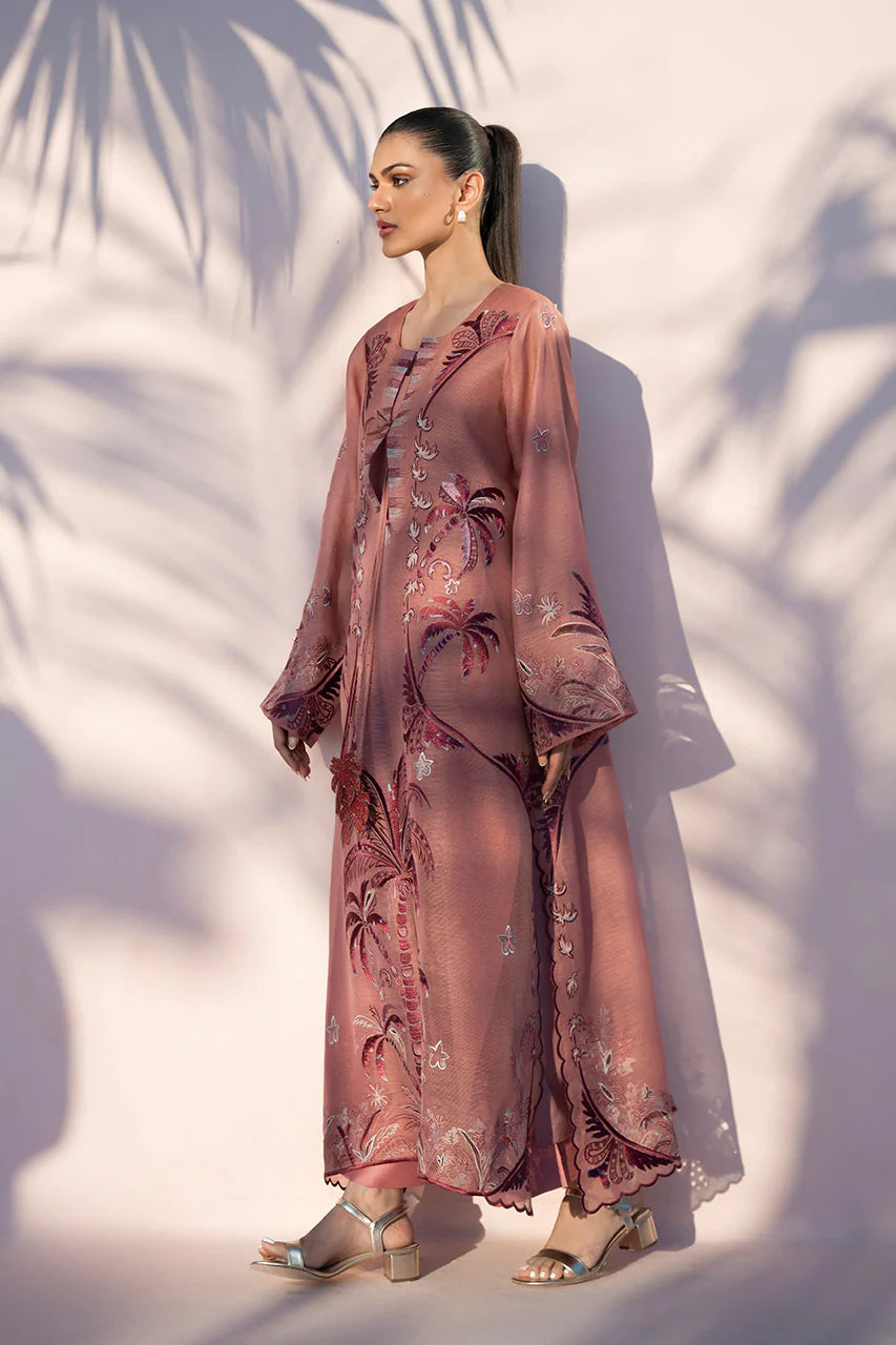 Woman wearing a pink floral outfit with palm leaf shadows on a white background
