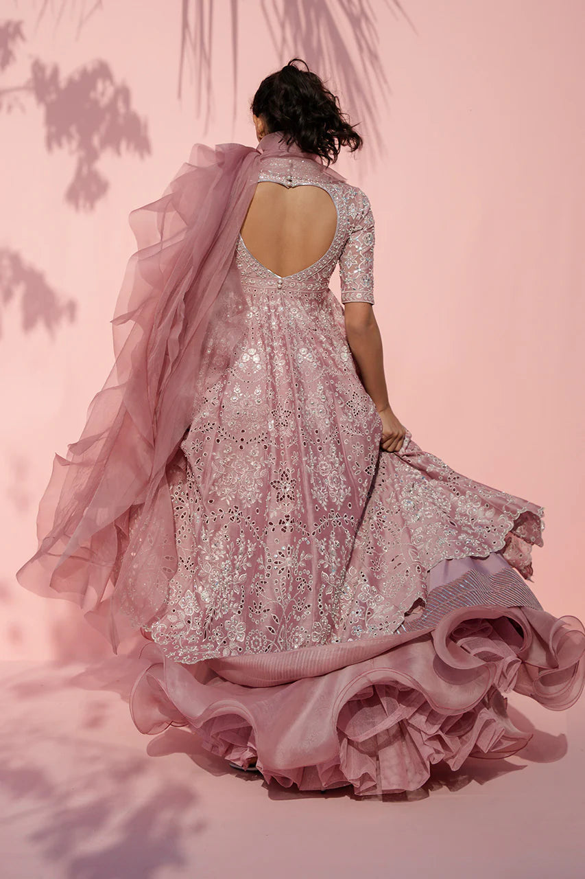 Pink embroidered gown with a matching dupatta against a pink background