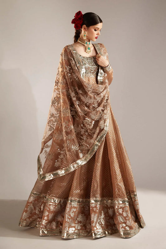 Woman wearing a traditional outfit with a floral headpiece against a plain background