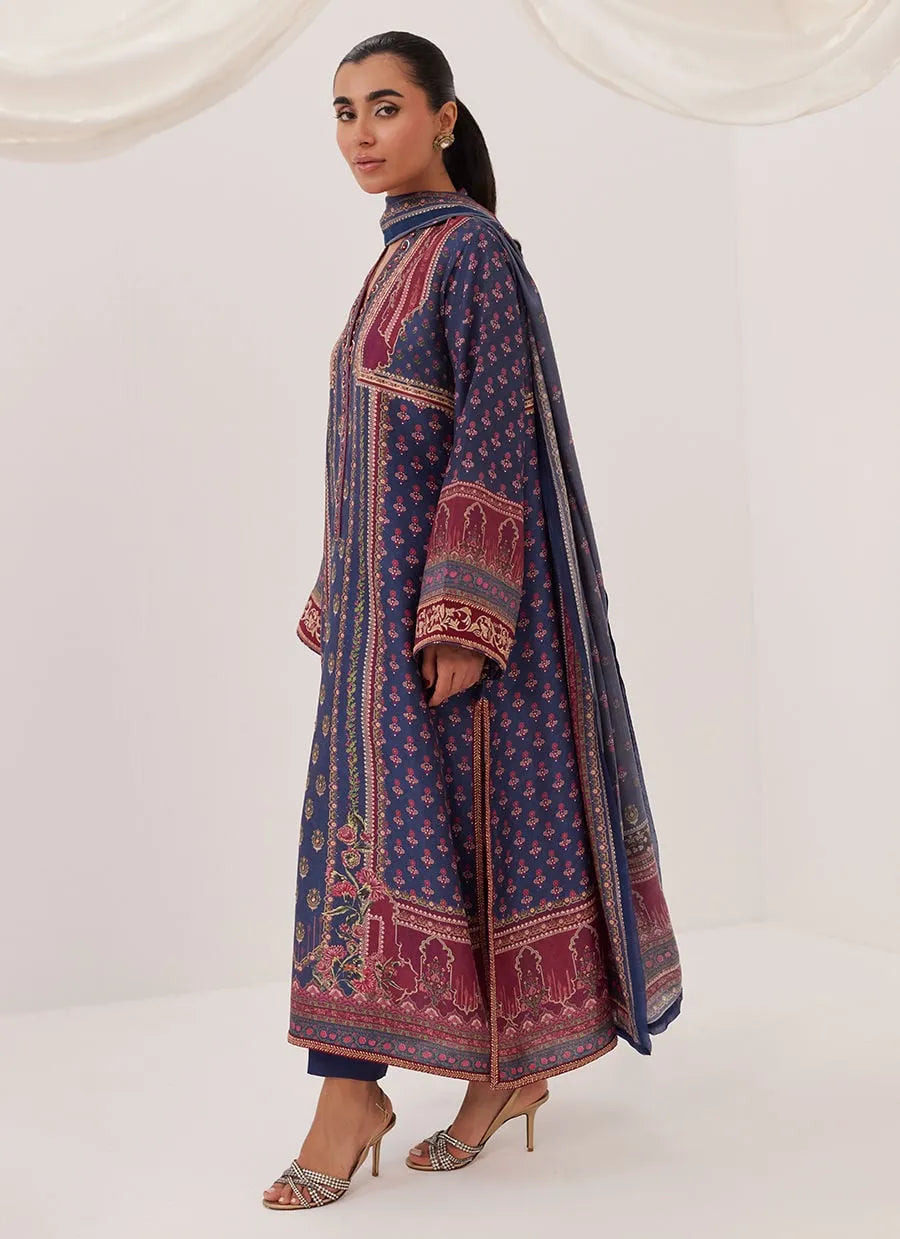 Woman wearing a patterned long dress on a white background