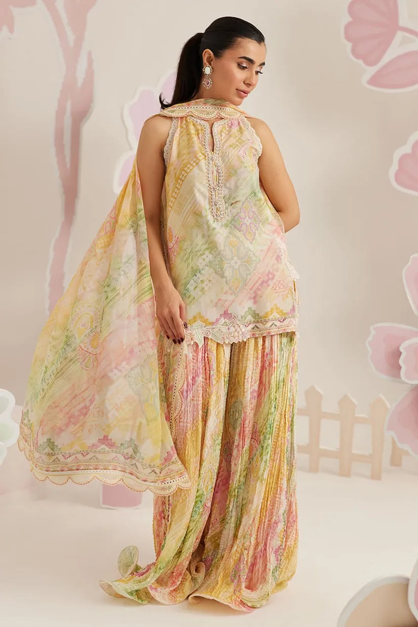 Woman wearing a floral dress with a soft pink background