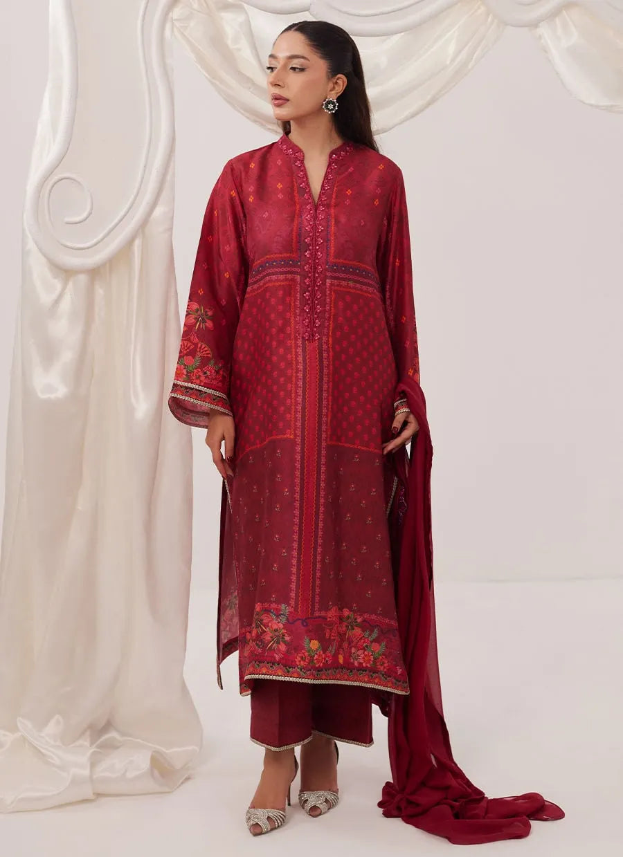 Woman wearing a red embroidered traditional outfit with a white curtain background