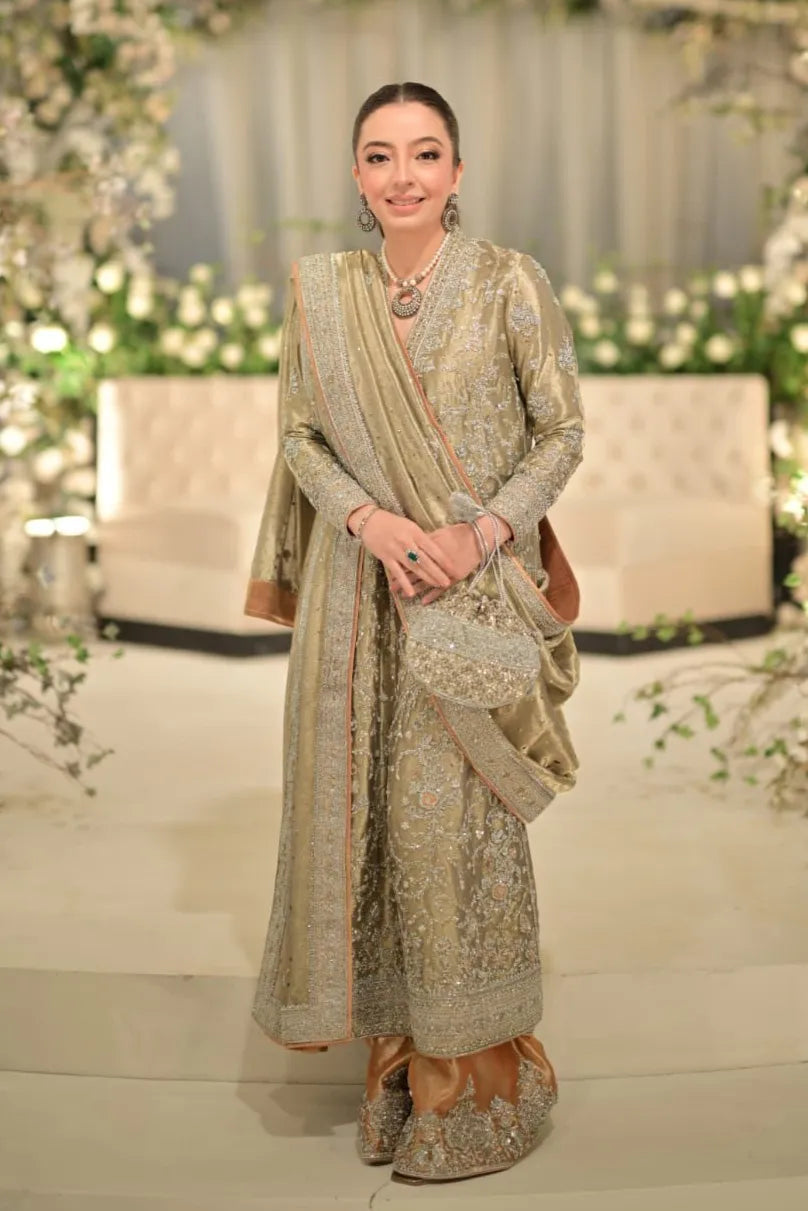 Woman in a traditional embroidered outfit with a floral background