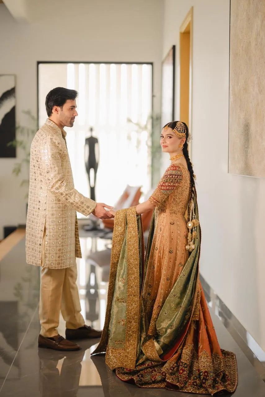 Man and woman in formal attire standing in a modern interior setting