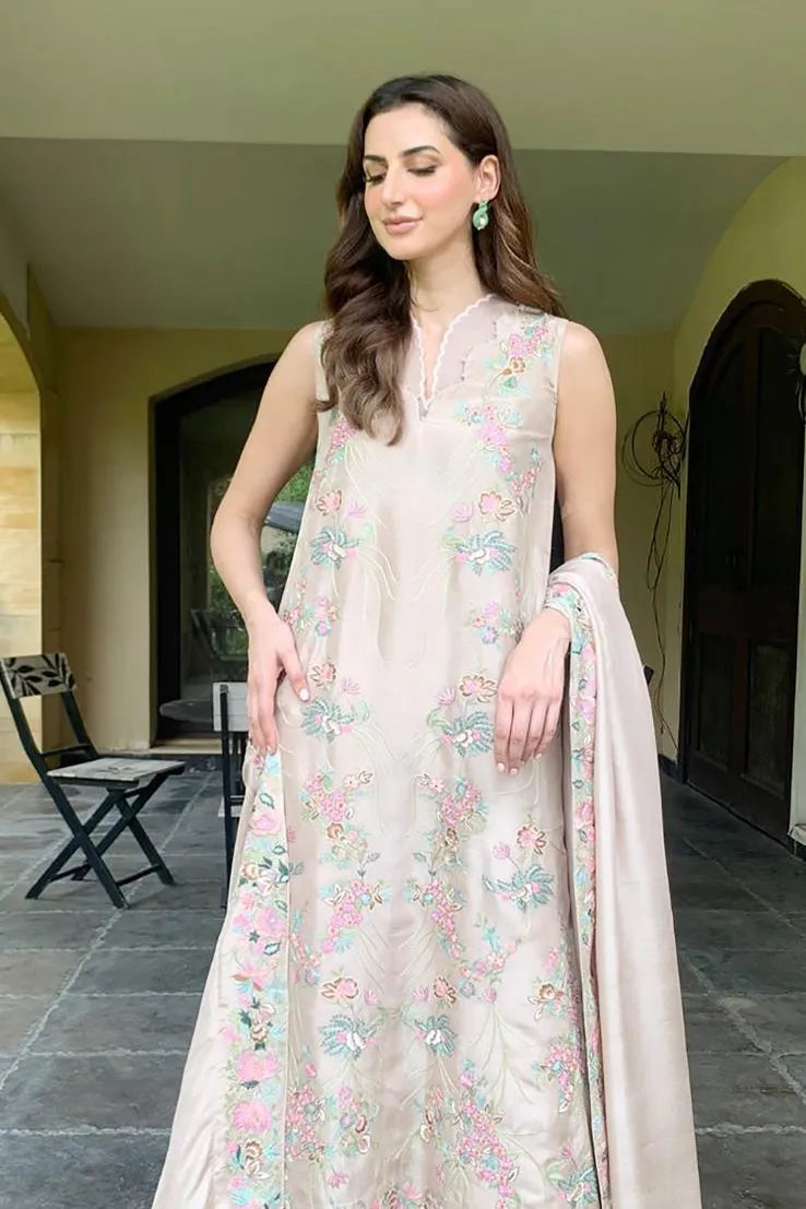 Woman wearing a floral dress standing outdoors.