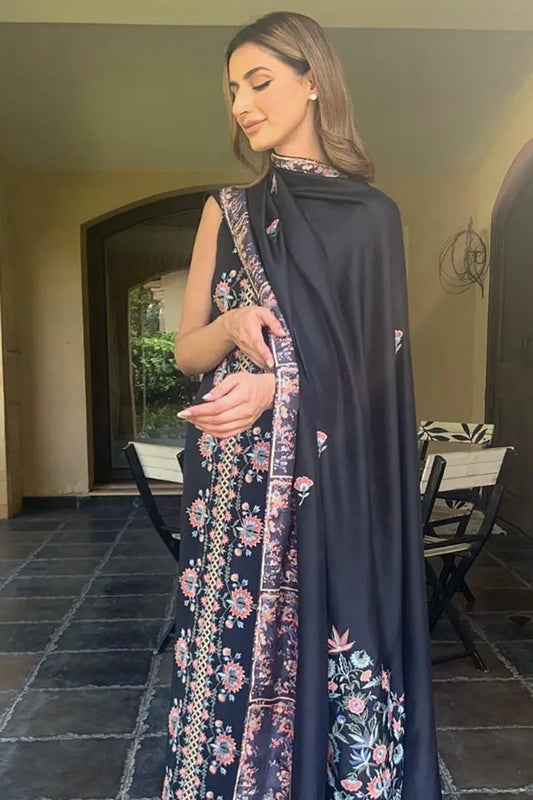 Woman holding a floral-patterned scarf in an indoor setting