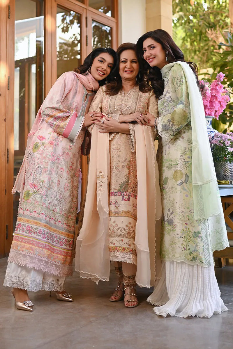 Three women in traditional outfits standing together outdoors.