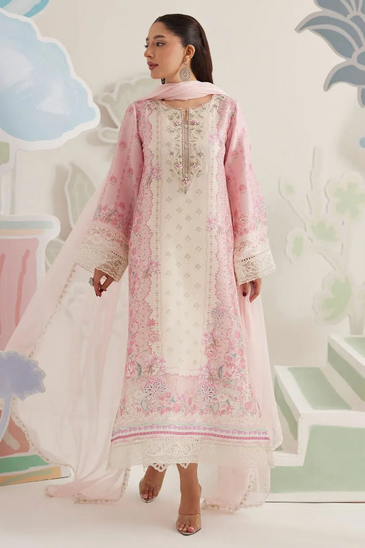 Woman wearing a pink and white embroidered traditional outfit with a light background