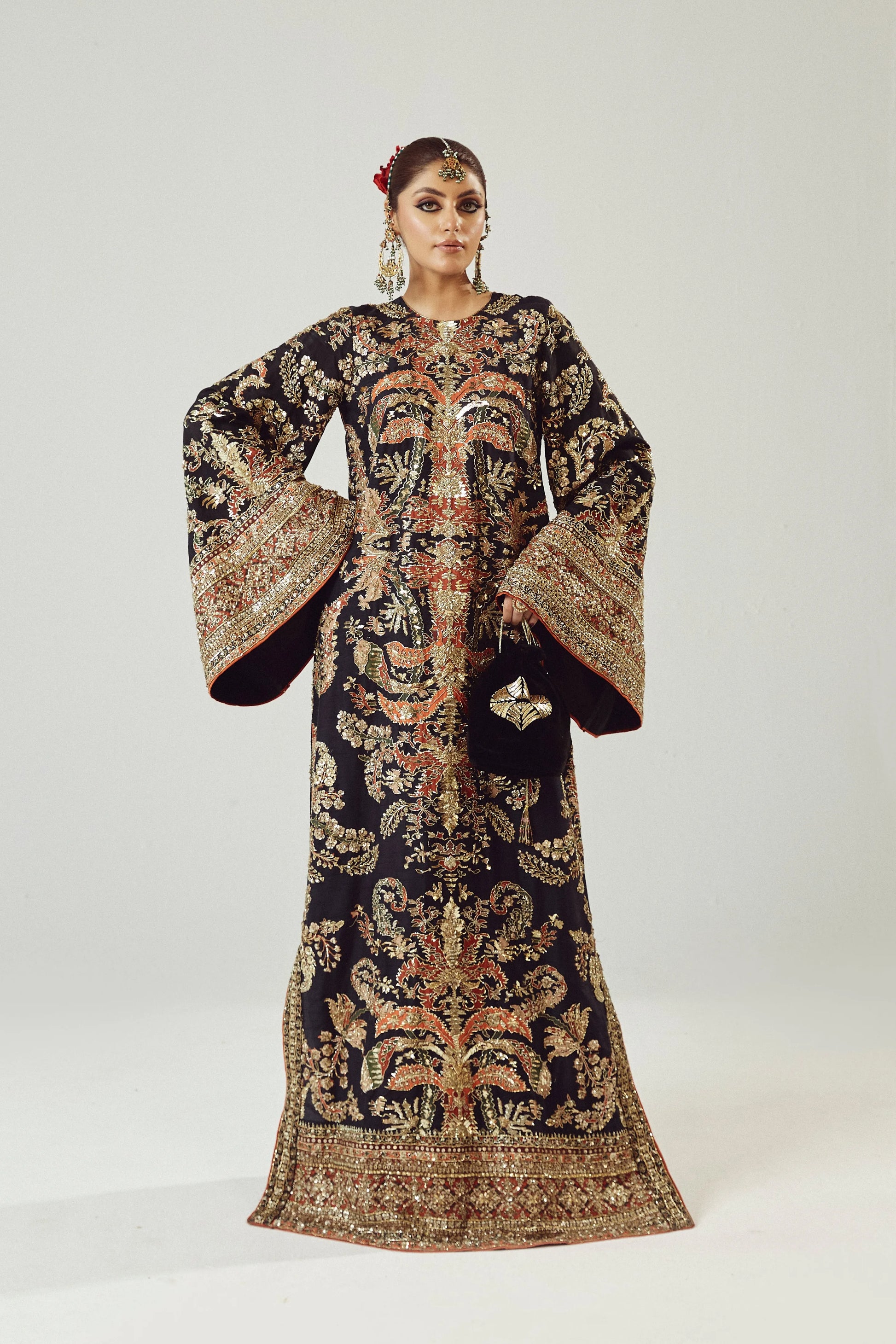 Woman wearing a traditional embroidered outfit on a white background